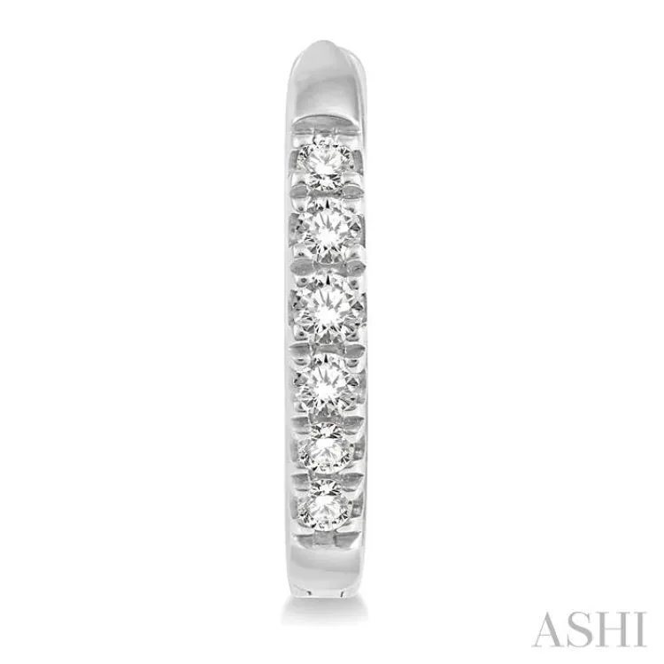 1/8 ctw Round Cut Diamond Huggie Earrings in 10K White Gold